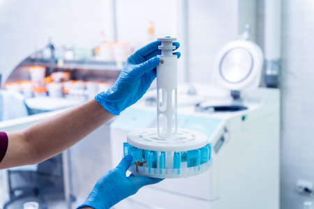 Laboratory assistant works with microwave hybrid tissue processor at the modern laboratory.の写真素材