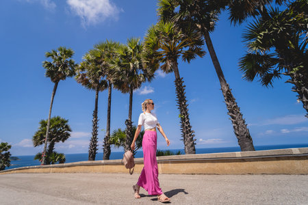 Young traveler woman at summer holiday vacation with beautiful palms and seascapes
