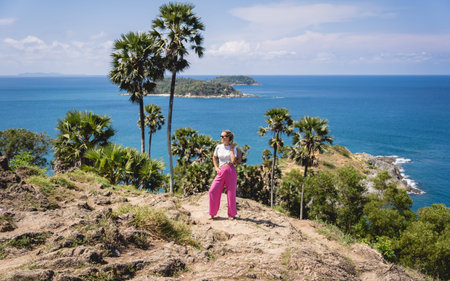 Young traveler woman at summer holiday vacation with beautiful mountains and seascapesの写真素材