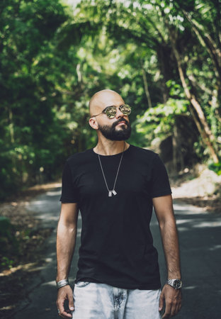 Portrait of a fashion young man at beautiful background in jungle