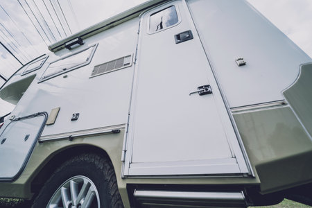 Travel camp trailer car with on the ground with grassの写真素材