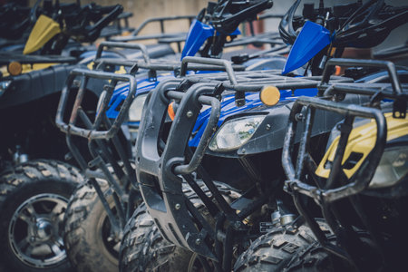 View of row dirty ATVs quad bike