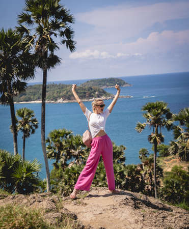 Young traveler woman at summer holiday vacation with beautiful mountains and seascapesの写真素材