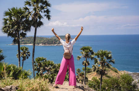 Young traveler woman at summer holiday vacation with beautiful mountains and seascapesの写真素材