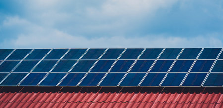 Solar panels on the red roof of civilian building