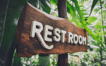 Wooden sign board with in tropical parkの写真素材