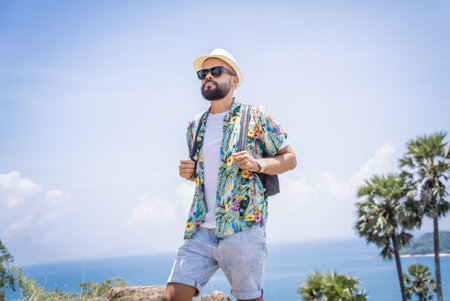 Young traveler man at summer holiday vacation with beautiful mountains and seascapes at backgroundの写真素材