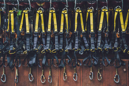 Rows of climbing safety ropes and carabiners and helmetsの写真素材