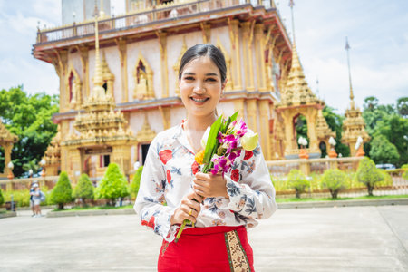 Beautiful Asian girl at big Buddhist temple dressed in traditional costume