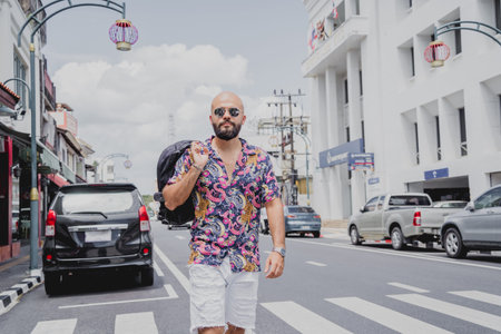 A young man travels with a backpack along the street of an asian city