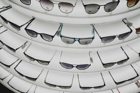 Rows of sunglasses on the counter of an optical storeの写真素材