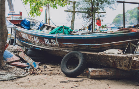 Old thai wooden boat on the beachの写真素材