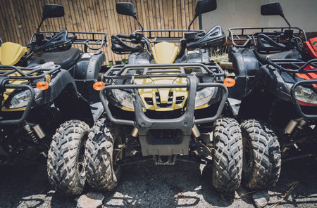 View of row dirty ATVs quad bike