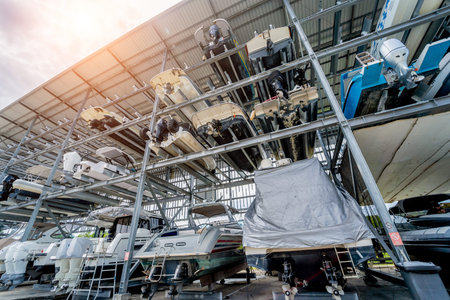 Speed motor boats are stapled in a garage system in the marina