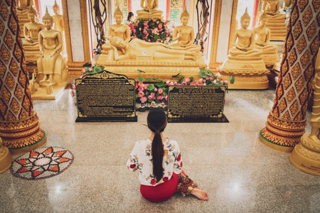 Beautiful Asian girl at big Buddhist temple dressed in traditional costume