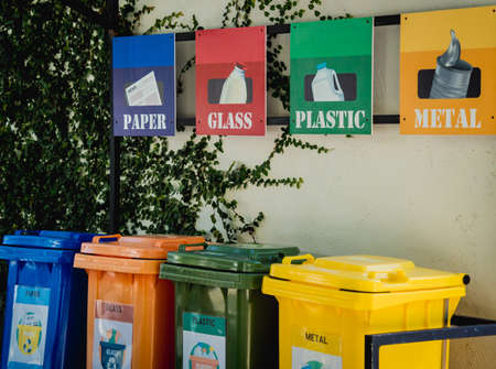 The four different container for sorting plastic, paper, metal and glass wasteの写真素材