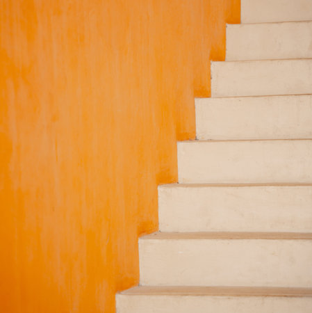 Metal stairs on the big orange wallの写真素材