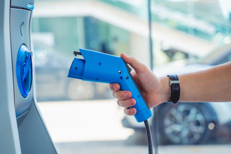 Man charge his electric car at city charging station