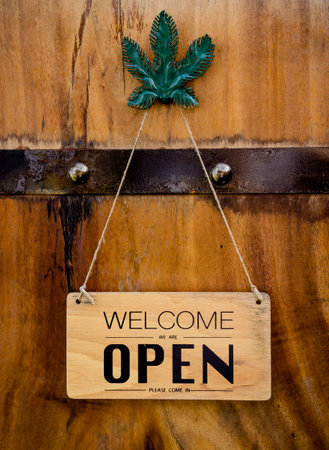 Wooden sign board with sign open in cafeの写真素材