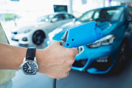 Man charge his electric car at city charging station