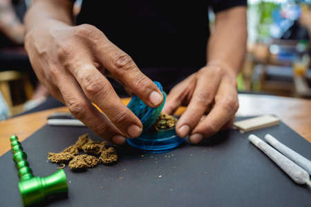 Young man making cigarettes with medical marijuanaの写真素材