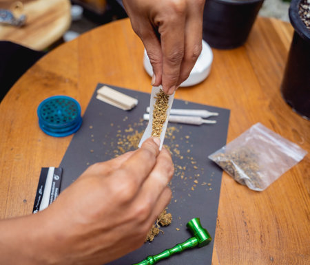 Young man making cigarettes with medical marijuanaの写真素材