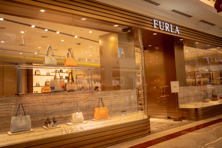 KUALA LUMPUR, MALAYSIA - DECEMBER 04, 2022: Furla brand retail shop logo signboard on the storefront in the shopping mallのeditorial素材