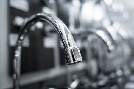Rows of metal water taps at the showroom of a large store