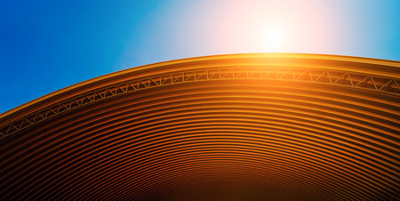 Abstract background spiral metal arch on blue skyの写真素材