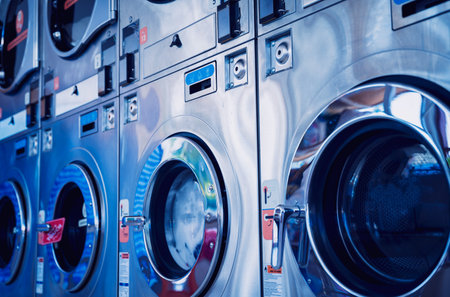 Rows of industrial laundry machines in the large laundromat.の写真素材