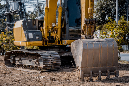 Excavator with shovel digs the ground for the foundation at constuction area.の写真素材