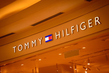 KUALA LUMPUR, MALAYSIA - DECEMBER 04, 2022: Tommy Hilfiger brand retail shop logo signboard on the...