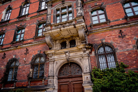 Facade of a old european historical building with vintage windows and doorsの写真素材