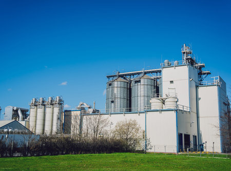 Modern silos for storing grain harvest at the blue sky background.