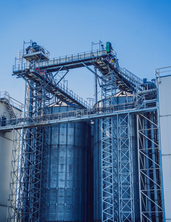 Modern silos for storing grain harvest at the blue sky background.