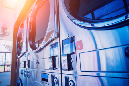Rows of industrial laundry machines in the large laundromat.