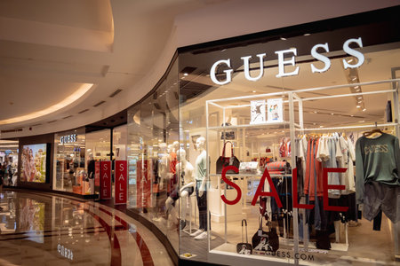 KUALA LUMPUR, MALAYSIA - DECEMBER 04, 2022: Guess brand retail shop logo signboard on the storefront in the shopping mallのeditorial素材
