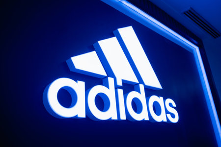 KUALA LUMPUR, MALAYSIA - DECEMBER 04, 2022: Adidas brand retail shop logo signboard on the storefront in the shopping mallのeditorial素材
