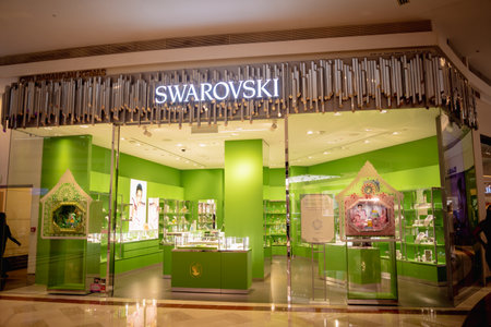 KUALA LUMPUR, MALAYSIA - DECEMBER 04, 2022: Swarovski brand retail shop logo signboard on the storefront in the shopping mallのeditorial素材