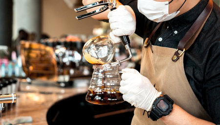 Barista preparing coffee drink at the big shopping mall