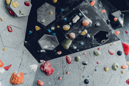 Artificial climbing wall with colorful grips and ropesの写真素材