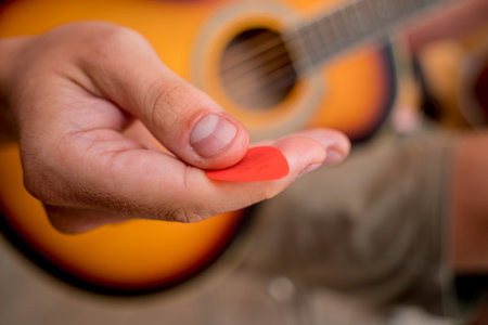 Young musician testing classical guitar in a guitar shopの写真素材
