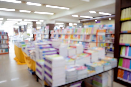 Bloored background of the book store with different books lying on the shelvesの写真素材