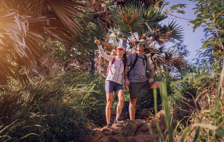 Happy young couple traveling in the jungle forest near the oceanの写真素材