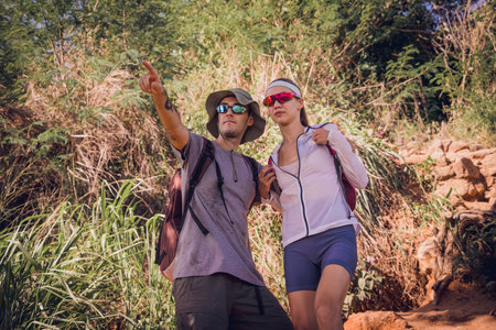 Happy young couple traveling in the jungle forest near the oceanの写真素材