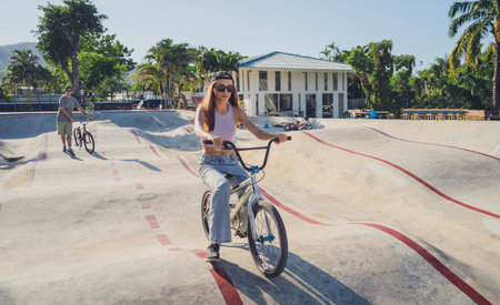 Happy young woman enjoy BMX riding at the skateparkの写真素材