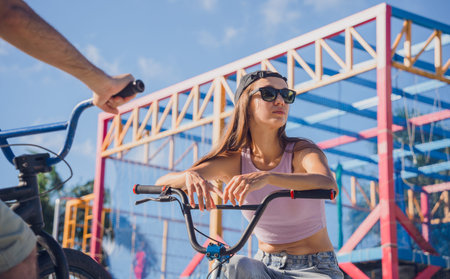 Young happy couple enjoy BMX riding at the skateparkの写真素材