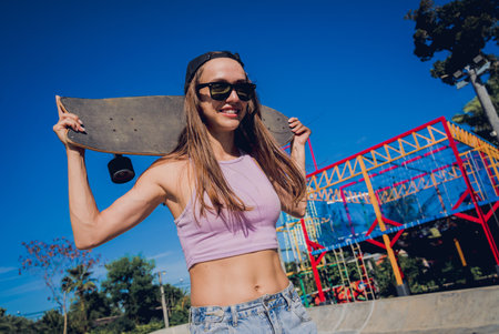 Happy young woman with skateboard enjoy longboarding at the skateparkの写真素材