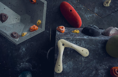 Artificial climbing wall with colorful grips and ropesの写真素材