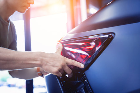 Replacing spare parts on a disassembled car in a car service garageの写真素材